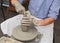 Potter shaping clay on a potter\'s wheel