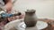 Potter teaches his craft to the children. Pottery class workshop. Clay shaping on potter\'s wheel and firing