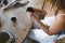 A potter woman sculpts clay at a table. Top view.