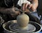 A potter works on a pottery wheel