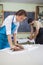 Pottering and Clay Making Process Concepts. Two Professional Clay Makers During a Process of Clay Preparation on Tables in