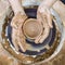 Pottering Ideas. Closeup of Dirty Male Potter Hands Moulding Jar