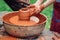 Potters and child hands. Pottery workshop outside. Master teaching kid to creating on the pottery wheel