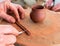 A pottery artist crafting a ceramic cup