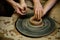 Pottery classes, student making clay pot on wheel. Close-up of dirty hands, sculpting clay crockery pottery training