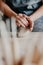 Pottery, clay, ceramics art concept - closeup on hands of young master with the large pieces of fireclay