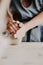 Pottery, clay, ceramics art concept - closeup on hands of young master with the large pieces of fireclay