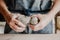 Pottery, clay, ceramics art concept - closeup on hands of young master with the large pieces of fireclay