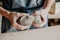 Pottery, clay, ceramics art concept - closeup on hands of young master with the large pieces of fireclay