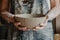 Pottery, clay, ceramics art concept - closeup on hands of young master with the large plate from fireclay