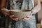 Pottery, clay, ceramics art concept - closeup on hands of young master with the large plate from fireclay