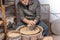 Pottery craftsman working on a potters wheel to make a bowl