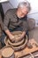 Pottery craftsman working on a potters wheel to make a bowl