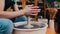 Pottery craftsmanship - a man forming piece of clay in longer shape spinning on a potter`s wheel