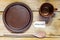 Pottery dishes and spoon on old wooden table, note with german w