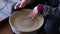 Pottery polishing process with 2 hands in the final step.