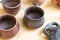 A pottery set consists of a pair of pots and a flask on a wooden background