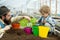 Potting flowers. father and son potting flowers. potting flowers with child and its father. father and little boy