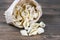 Pouch bag with pasta conchiglie flatlay, top view. Packaging on dark wooden background. Italian conchiglie or durum wheat shells