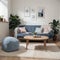 Pouf on blue carpet in bright living room interior with grey chair and settee against the wall with gallery