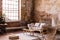 Pouf and wooden table on carpet near window in wabi sabi interior with sofa and armchair