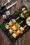 Poultry meat skewers - grilled meat with lime slices on wooden table