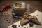 Poultry pate spread on bread and glass jar with poultry pate, decorated with almonds and rosemary, and a few fruits of hot pepper