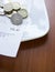 Pound coins and bill on plate close-up