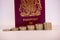 Pound Coins Stacked in front on UK Passport