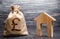 Pound sterling GBP symbol money bag and house. Real estate purchase and investment. Affordable loan, mortgage. Taxes, rental