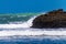 Pounding surf rolling into Bethels Beach. Auckland, New Zealand