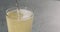 Pour apple cider into pint glass closeup