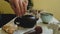 Pour boiling water into the teapot. Chinese tea ceremony. Ceramic kettle. Close-up. Slow motion