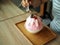 Pour condensed milk over a pink milk kakigori or Japanese shaved ice dessert flavored, topped with pink whipped cream.