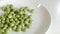 Pour the green peas into the dish intermittently without spilling.