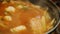 Pour hot soup from seafood ladle. Authentic Korean cuisine