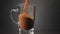 Pour instant coffee into a glass mug. Slow motion