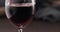pour red wine into wineglass closeup indoor shot