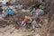 Poured garbage on Sea coast is left by tourists and vacationers. Dirty sea sandy shore of  Sea. Environmental pollution.