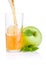 Pouring apple juice into a glass, green apples