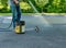 Pouring asphalt sealant on driveway