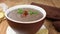 Pouring bacon and parsley in traditional Brazilian soup called caldo de feijÃ£o