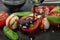 Pouring balsamic vinegar onto fresh vegetable salad on plate