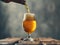 Pouring beer from beer bottle in glass serving in a gray background.