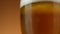Pouring beer in glass. Cold Glass of beer close up with froth, rotation.