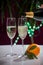 Pouring of brut champagne, cava or prosecco wine in glasses with garland lights on dark background, new year or birthday party