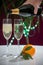 Pouring of brut champagne, cava or prosecco wine in glasses with garland lights on dark background, new year or birthday party