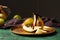 Pouring of chocolate sauce onto ripe pears on metal tray