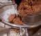 Pouring cocoa powder into a sieve.