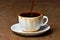 Pouring coffee into overflowed white porcelain mug with saucer. Cup with overflowing coffee. Full cup of coffee on wooden table